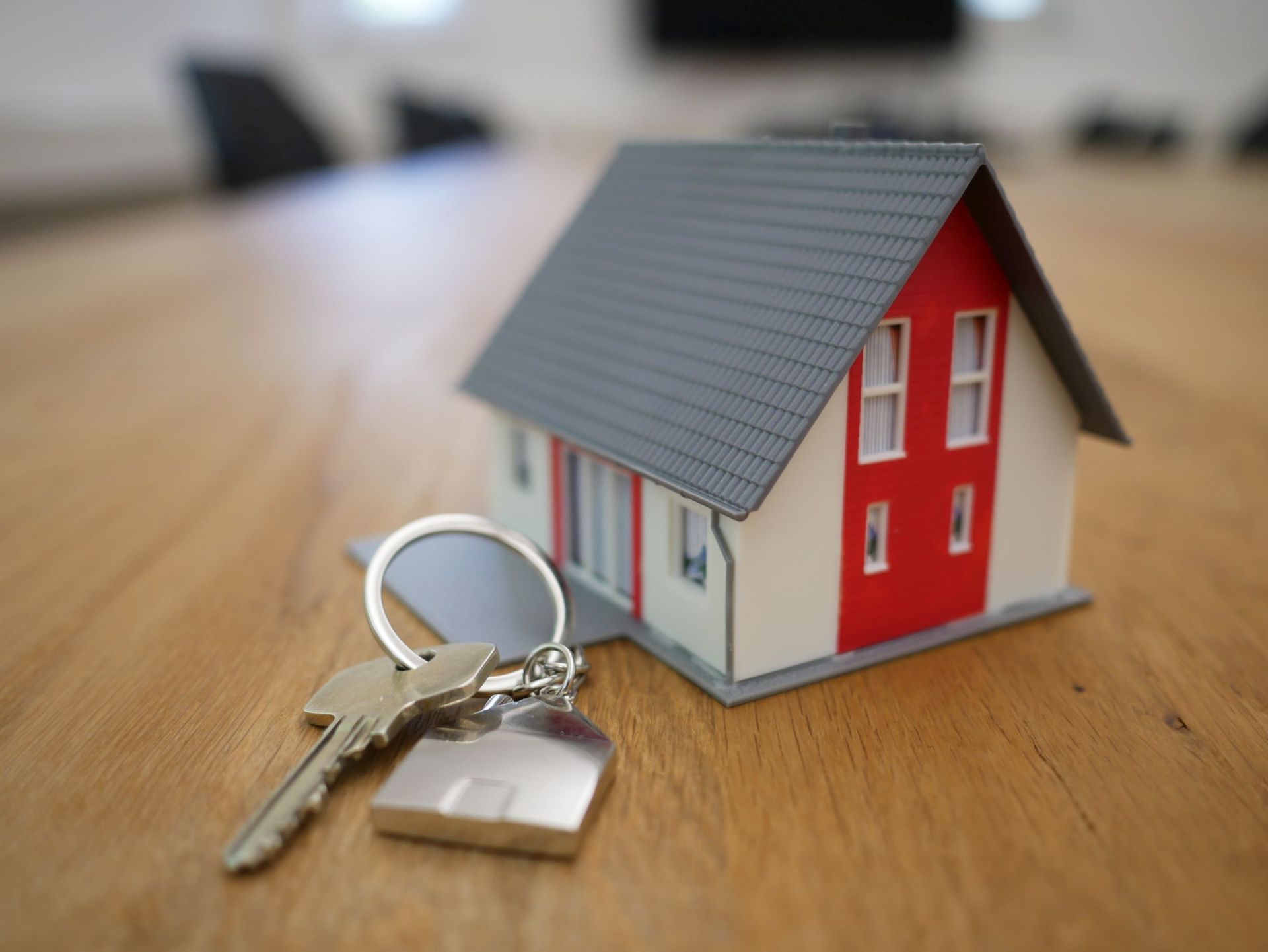 Small model of a home with a key and keychain